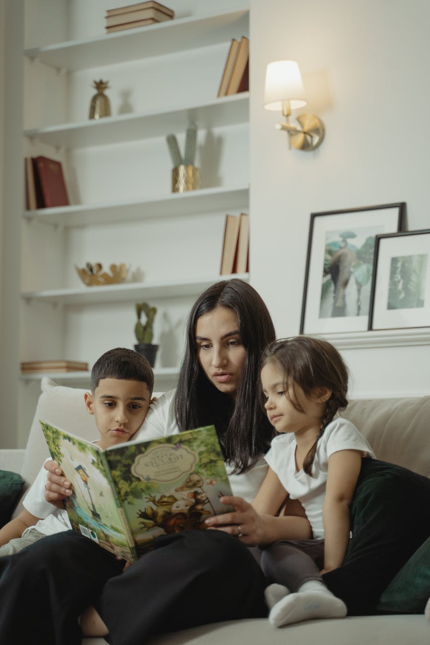 a mother reading a book to her children